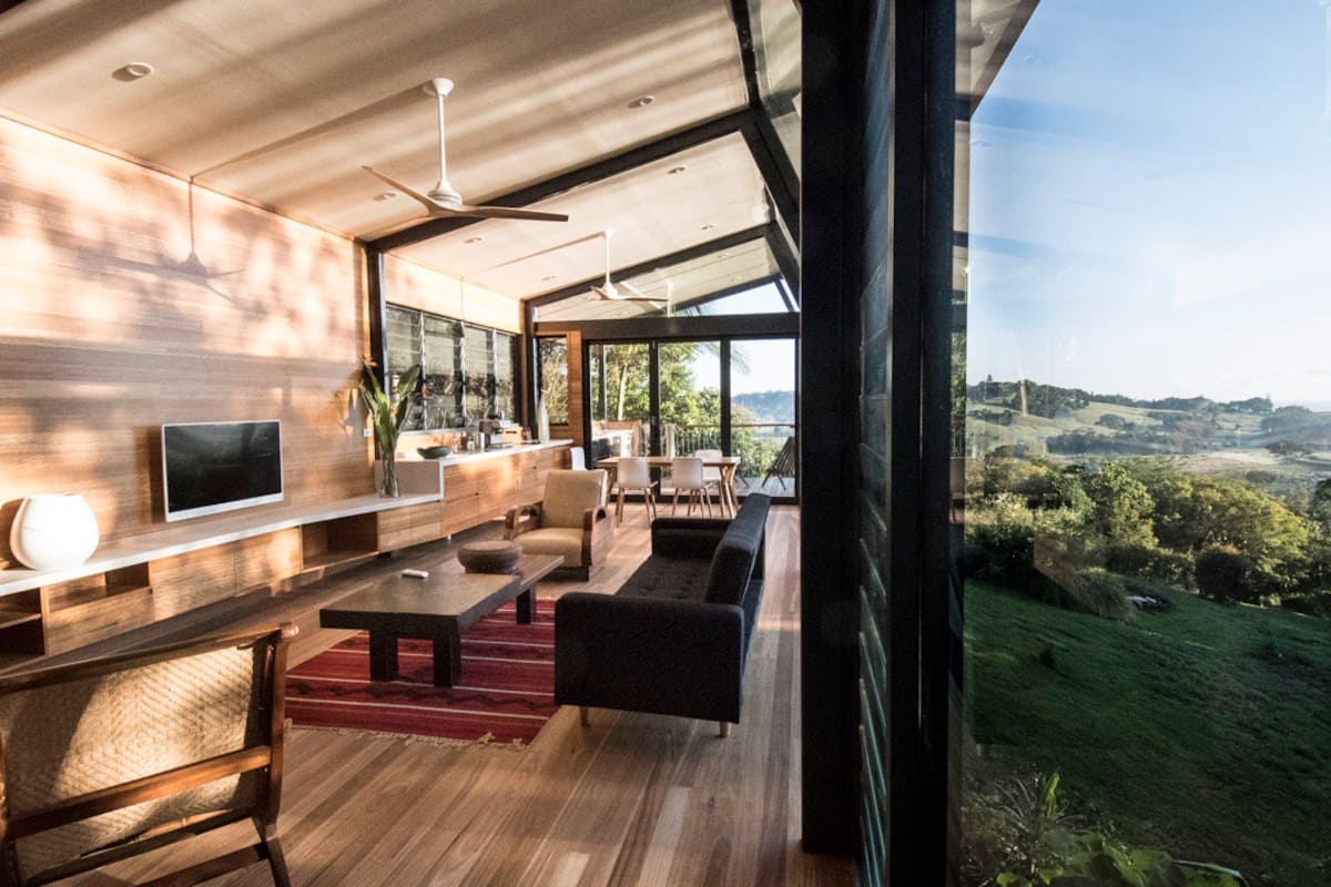 a house with glass walls looking out over valleys