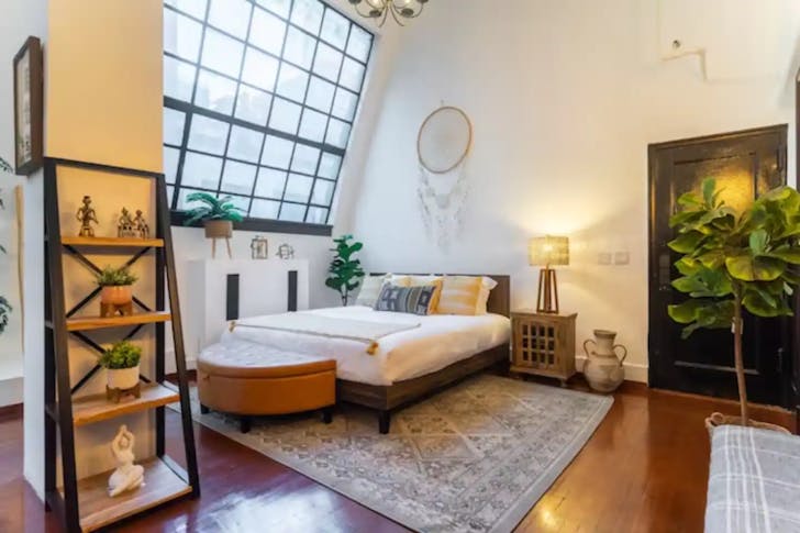 Bed below large window 