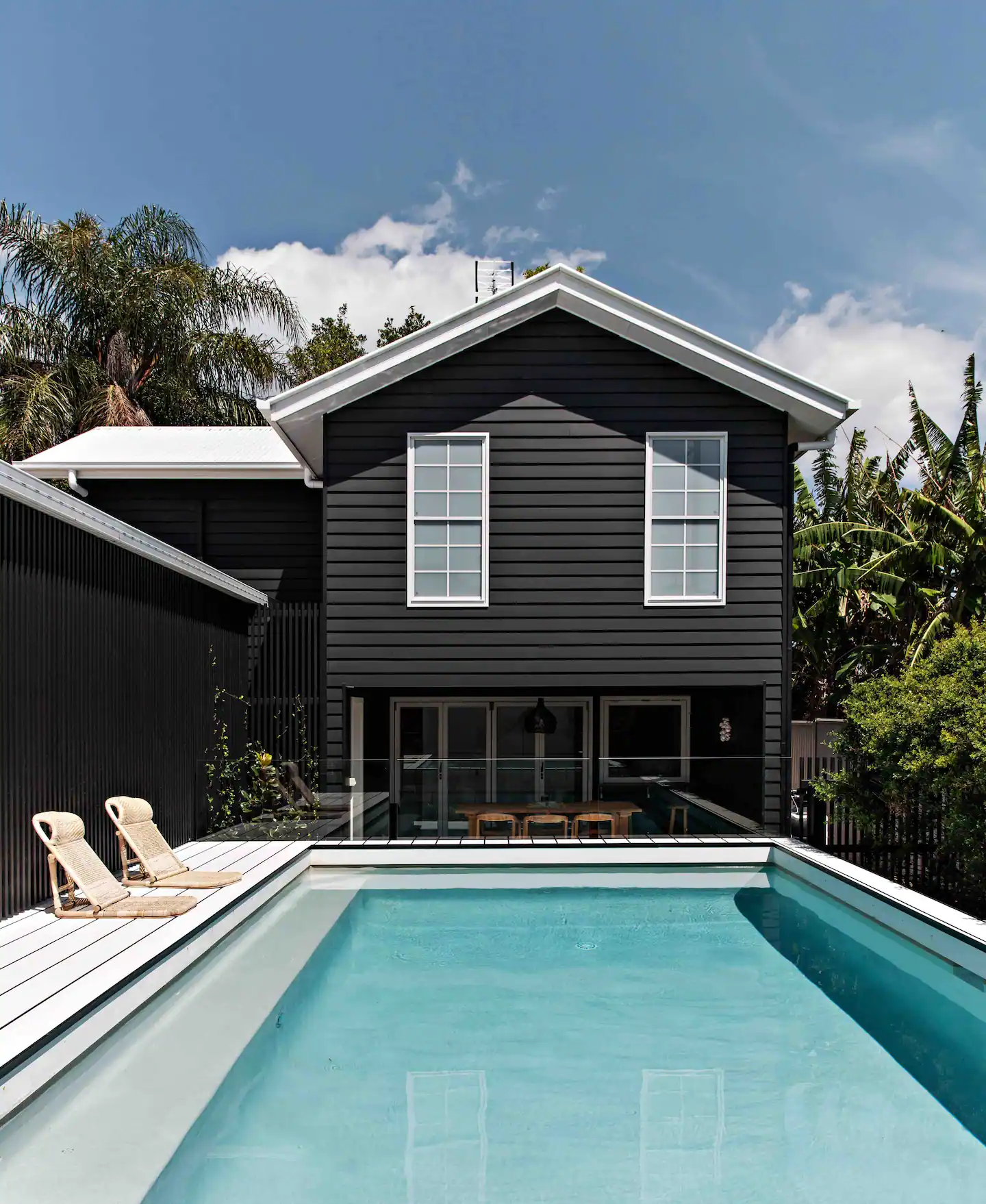 a dark house overlooking a pool