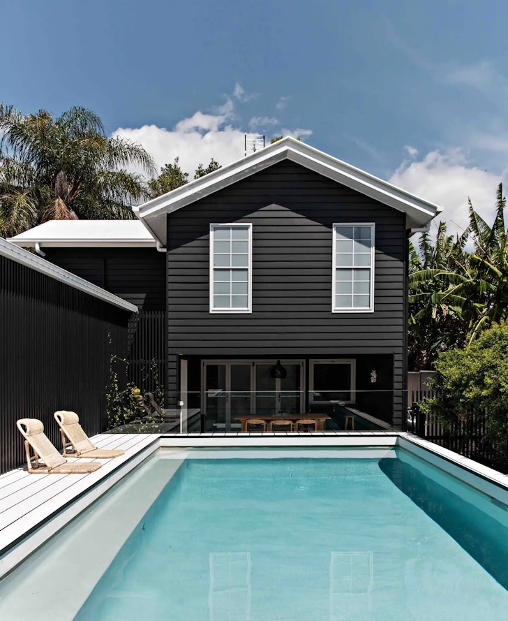 a dark house overlooking a pool