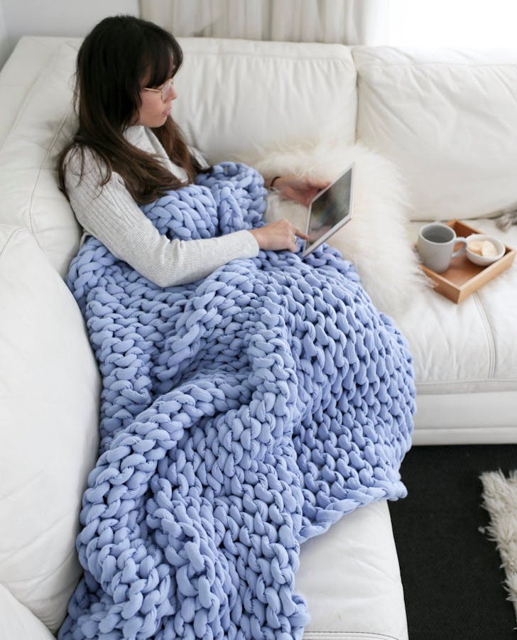 a woman under a woven blanket