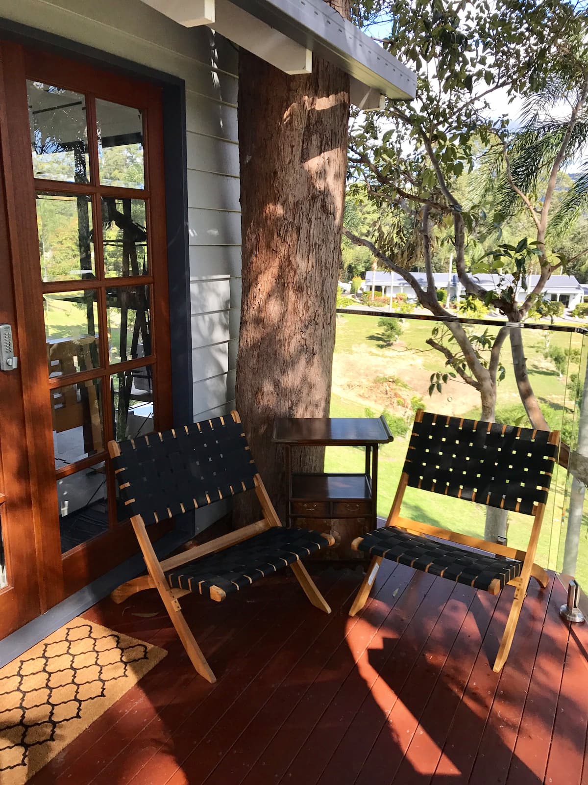 a deck on a small cabin with two chairs