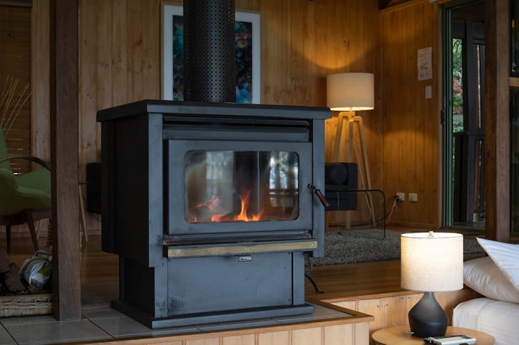 The huge black fireplace at Treetops Seaview cabin near Brisbane