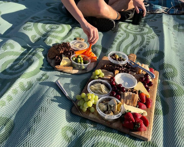 Hand digging into a cheeseboard