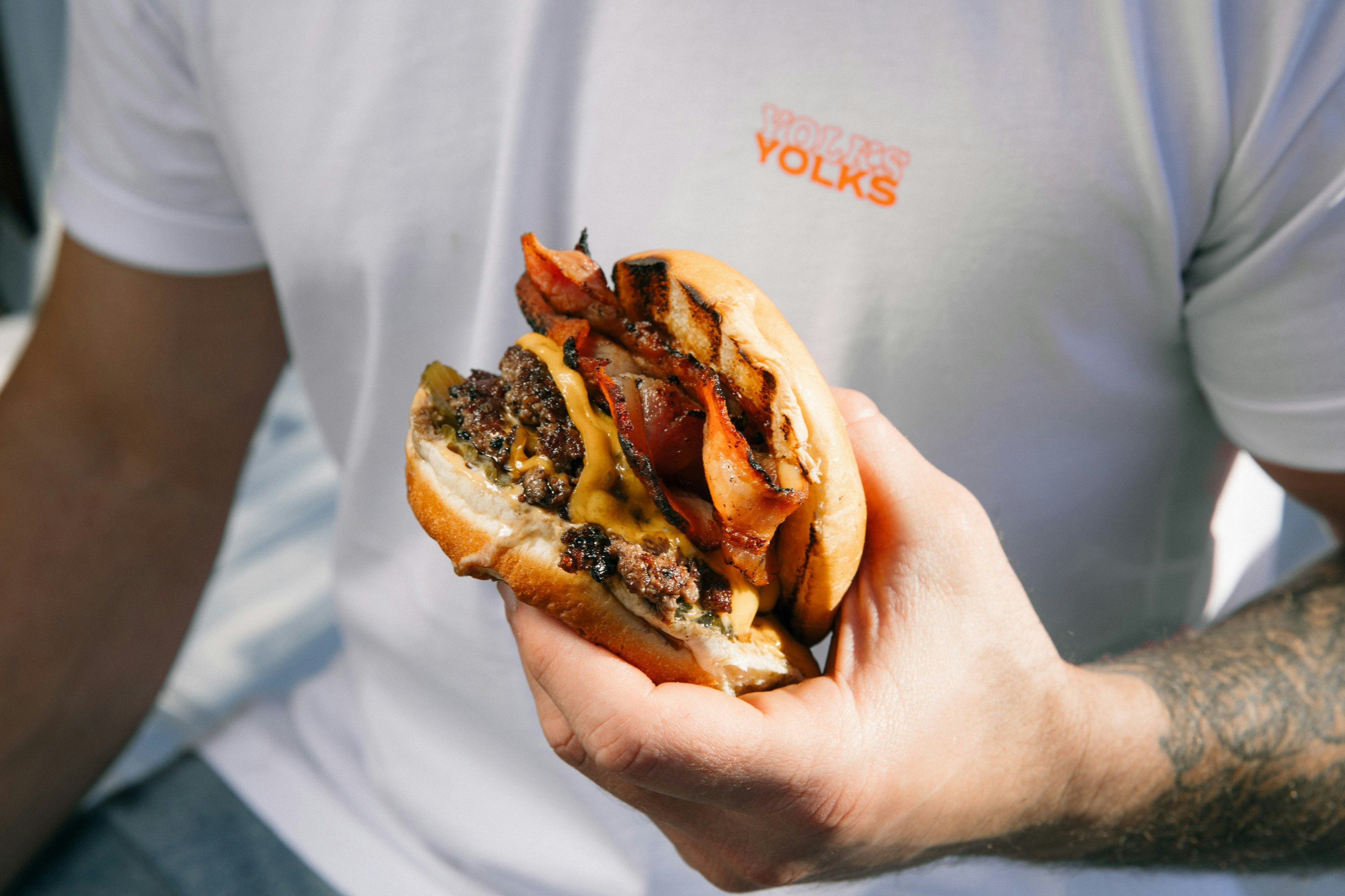 someone holding a burger