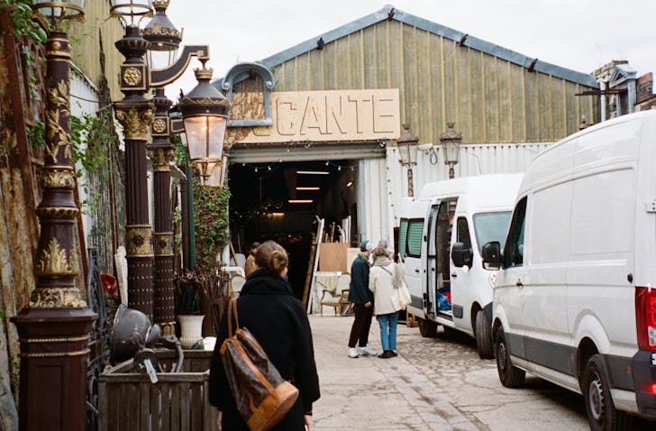 People walking into an antique store housed