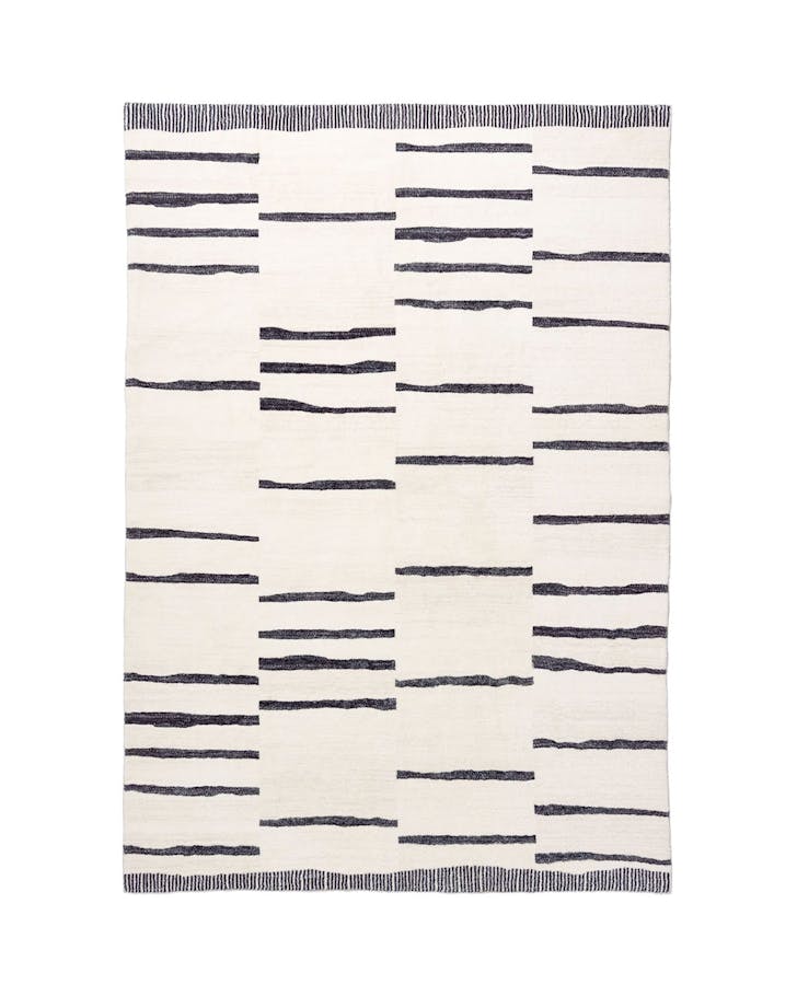 A black and white striped machine washable rug from Miss Amara. 