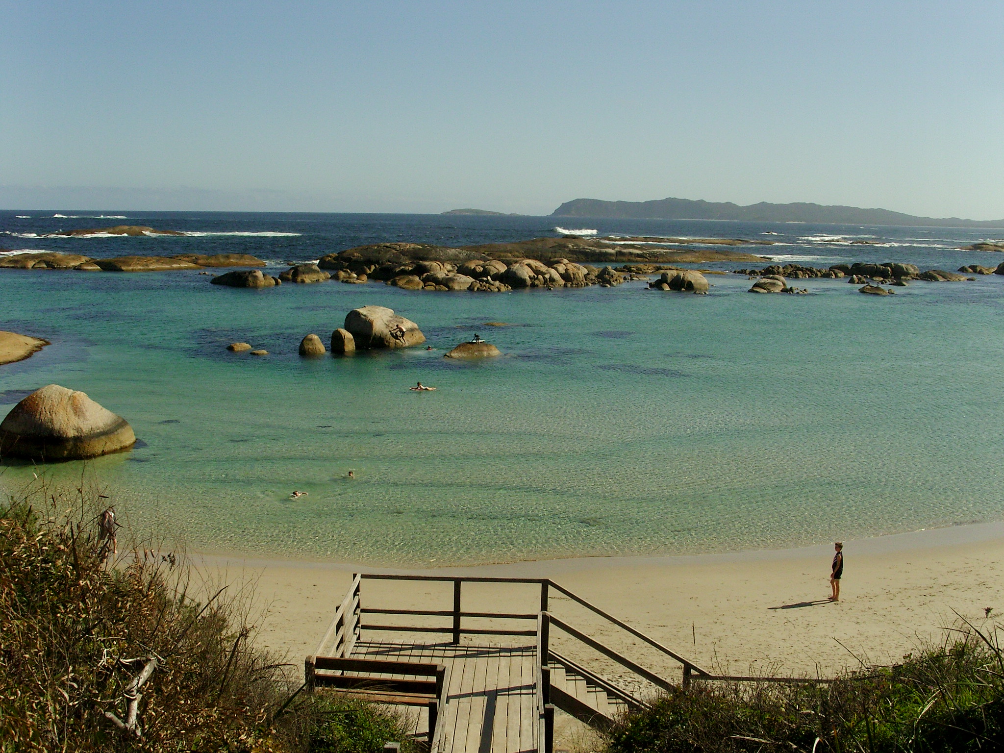 a view of a bay filled with granite boulders