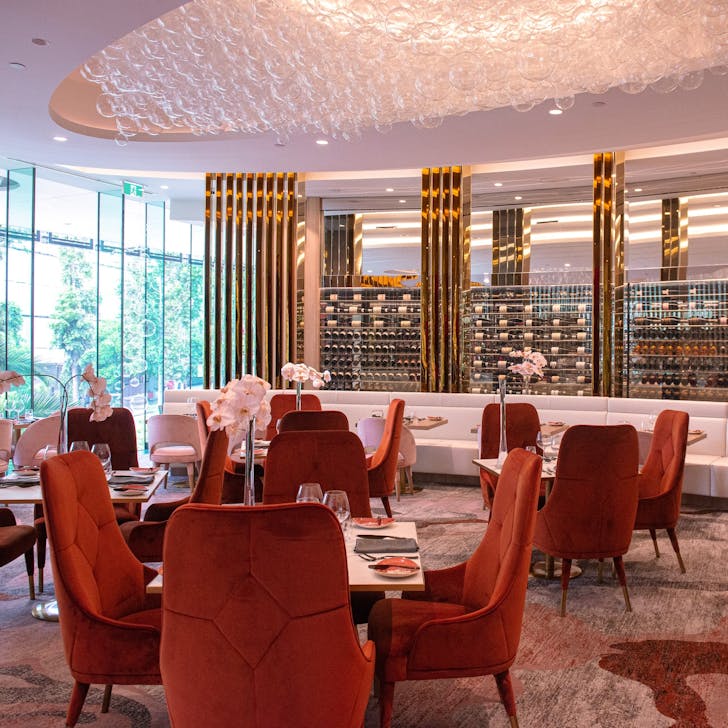 interior of a luxe restaurant with pink velvet chairs