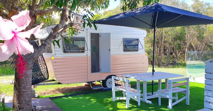 a pink and white vintage caravan
