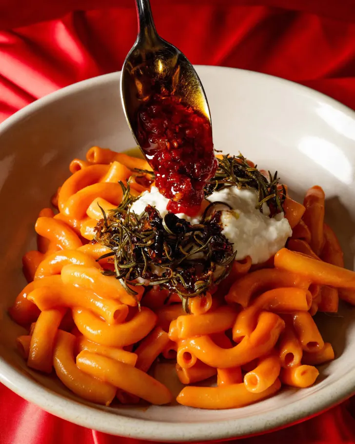 Plate of macaroni with chill on a spoon