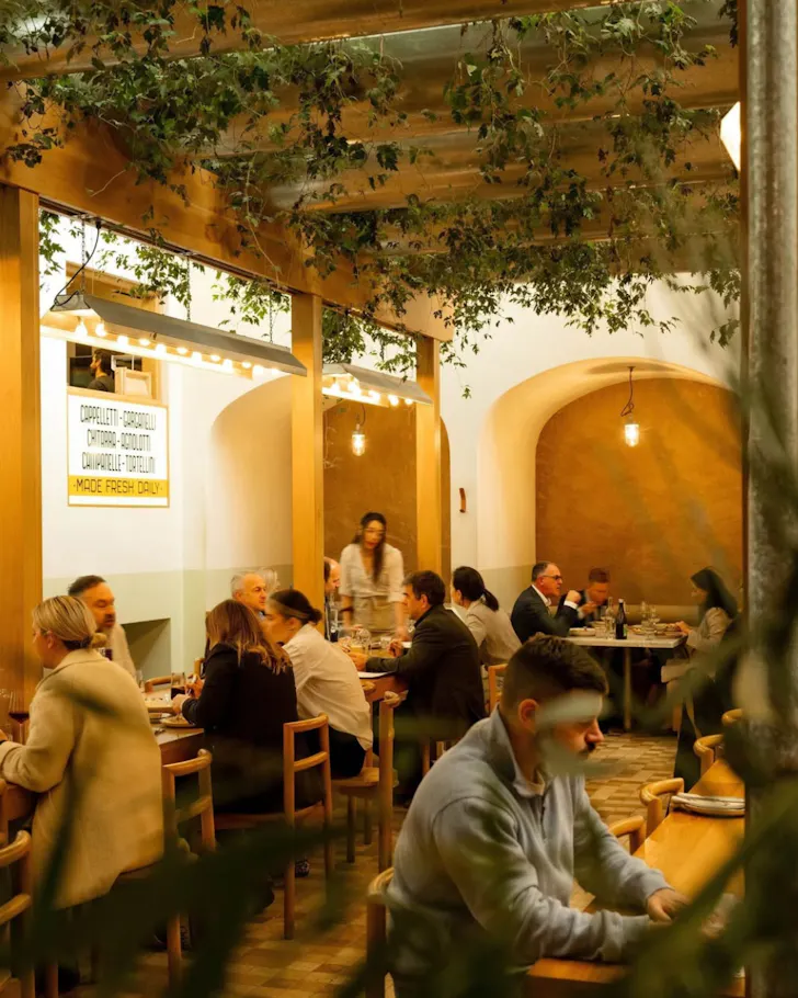 Room of people with vines on roof