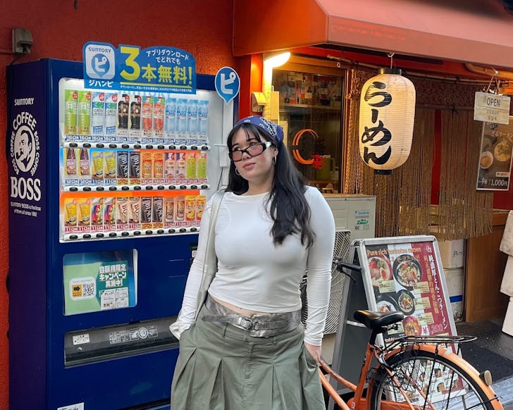 Person posing in front of machine