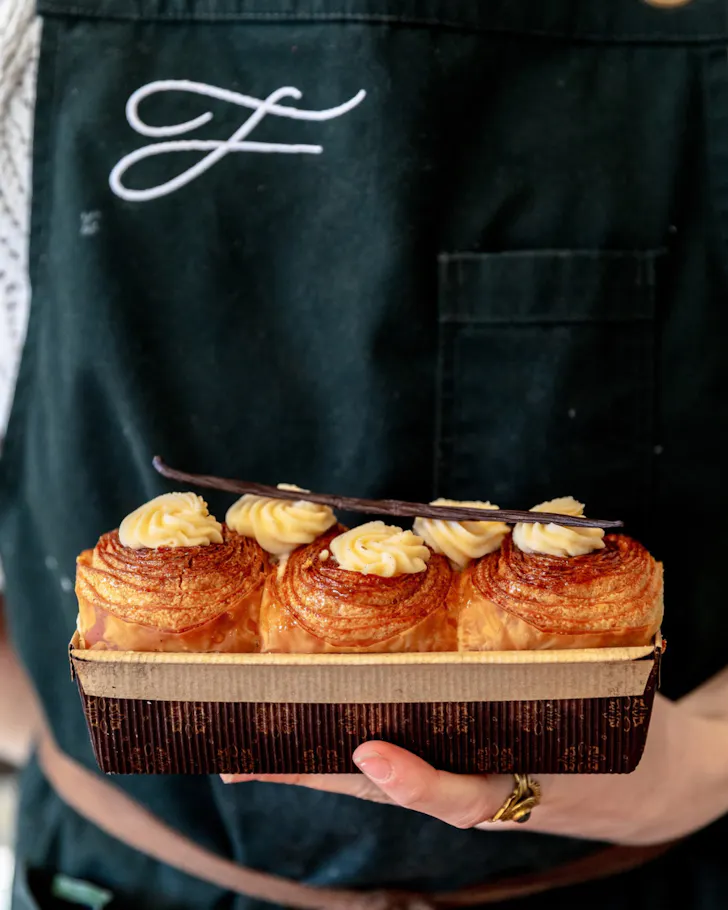 Hand holding tray of pastries