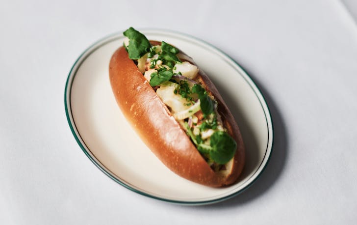 A white table with a small plate and a best lobster Melbourne has on it. 