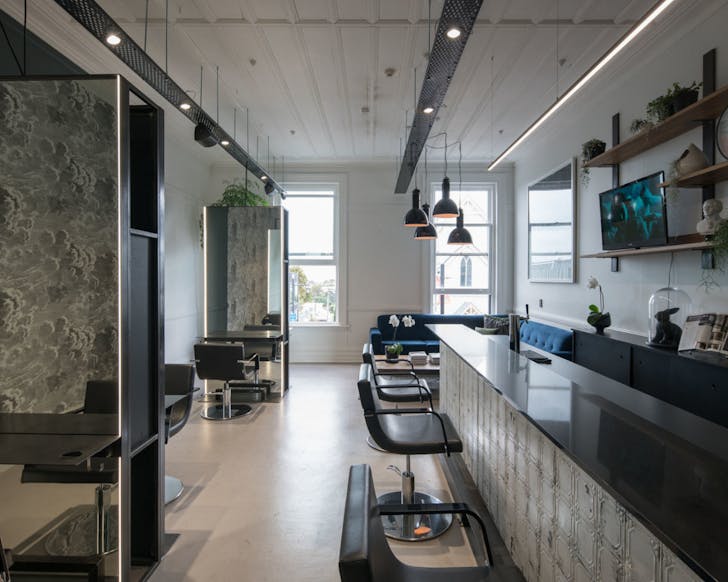 Inside of the salon with artistic dÃ©cor and a posh lounge area
