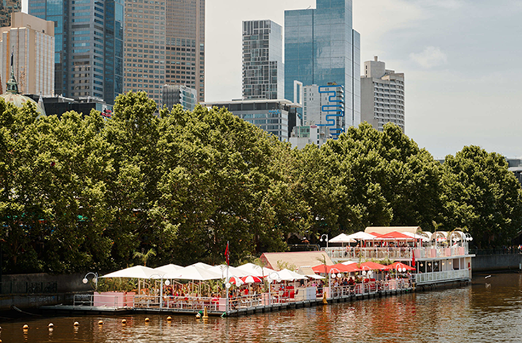 A shot of Arbory Afloat from a distance with the river and the city in the background. 