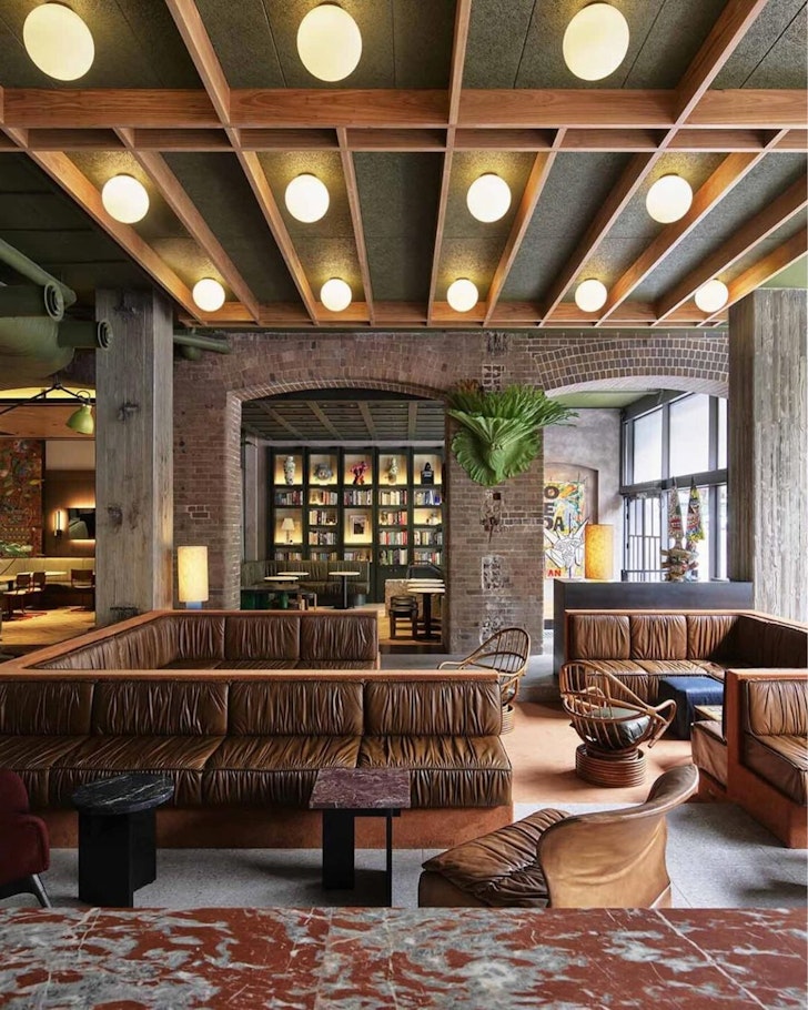 A view of the bar and lobby with cosy leather couches at Ace Hotel Sydney one of the best hotels in Australia