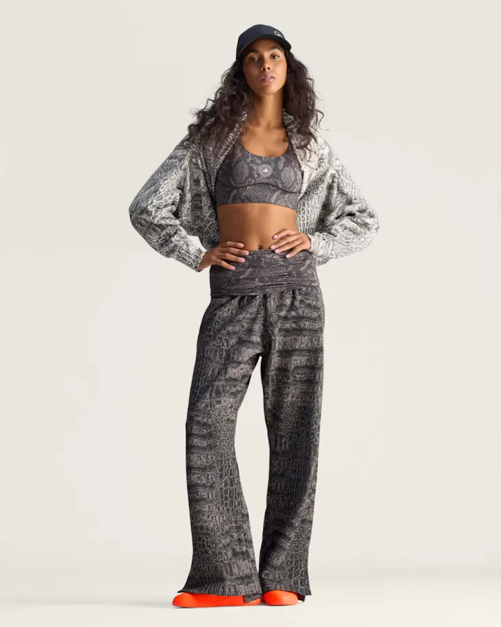 A woman wears the Stella McCartney Power Impact Training Bra and matching pants from Adidas one of the best activewear brands