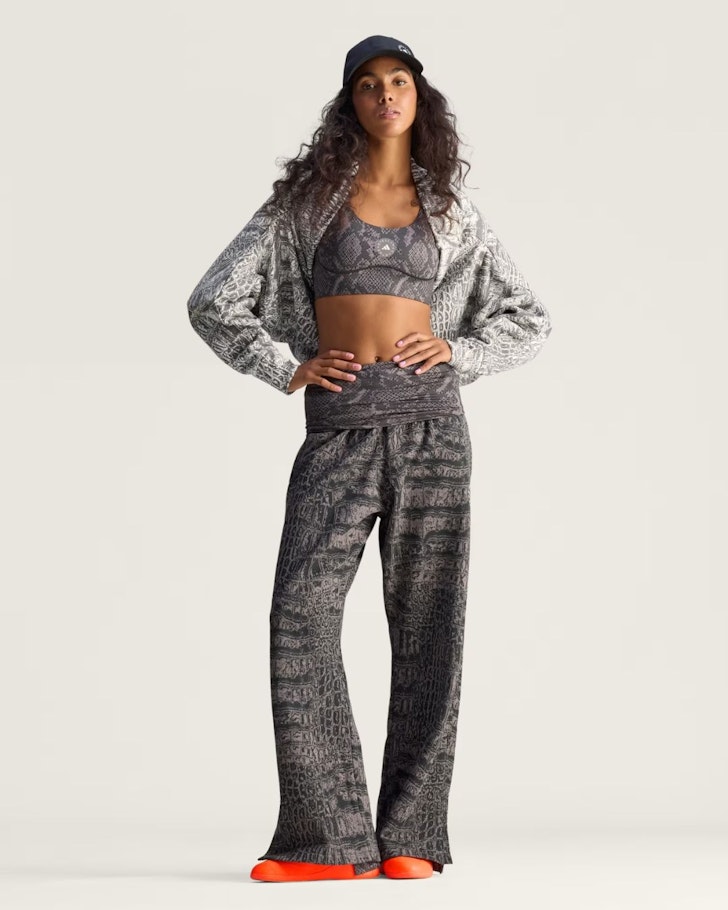 A woman wears the Stella McCartney Power Impact Training Bra and matching pants from Adidas one of the best activewear brands