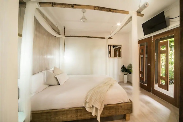 A view of the four-poster bed at Havana Retreat one of the best Airlie Beach Airbnbs