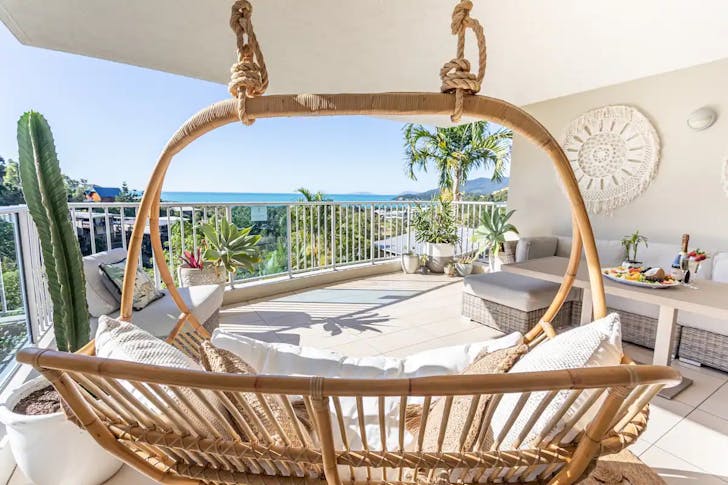 view of Airlie marina from balcony with seating