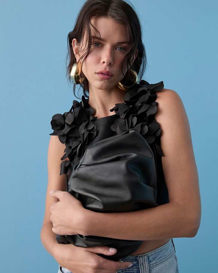 A woman wears a top from Aje one of the best Australian fashion brands