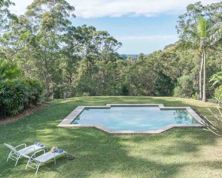 Outdoor pool with two pool lounge chairs