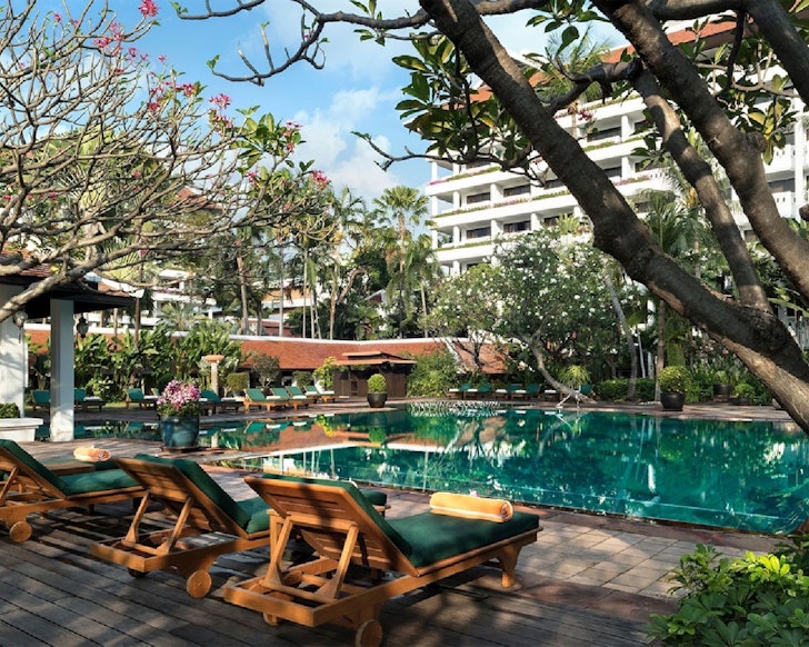 The pool surrounded by greenery at Anantara Riverside Bangkok Resort one of the best Bangkok hotels