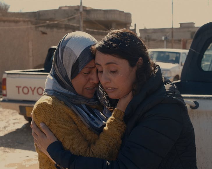 Two women comfort each other