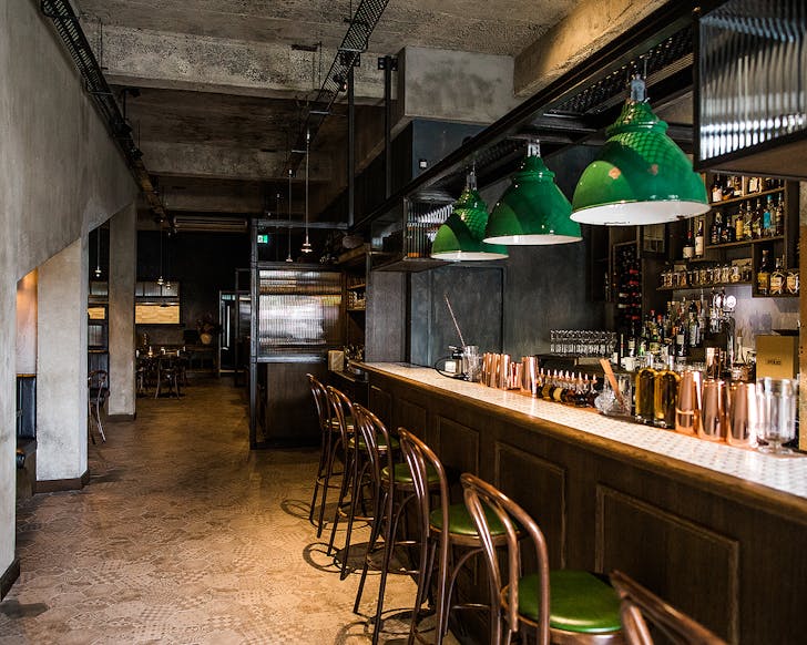 The interior at V.T Station shows green accents and a lovely looking bar.