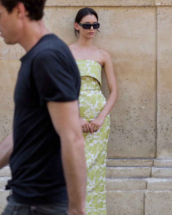 A woman stands in the street wearing a dress from Anna Quan one of the best Australian fashion brands