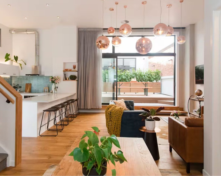A view of the living space leading out to the deck at Anzac North Loft Apartment one of the best Auckland Airbnbs