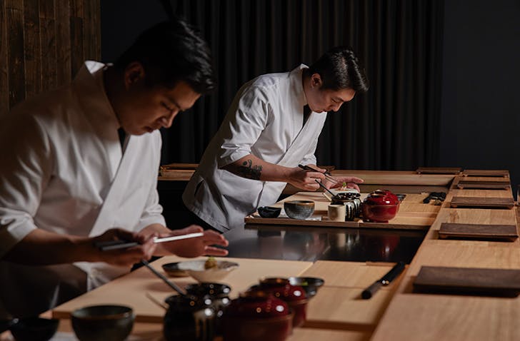 Two chefs carefully preparing Japanese cuisine in one of the best Japanese Melbourne restaurants, Aoi Tsuki.