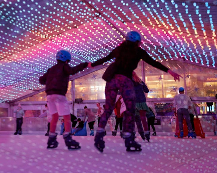 A parent and child take to the ice at the Aotea Square Ice Rink. 