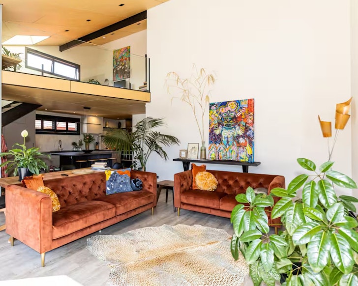 The artistic living space with artwork and plants at Arthouse Botanic one of the best accommodation options in Lake Tekapo New Zealand