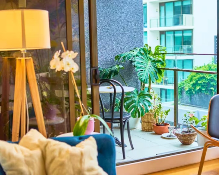 A view of the balcony with plants at Artsy Apartment pet-friendly Airbnb Brisbane