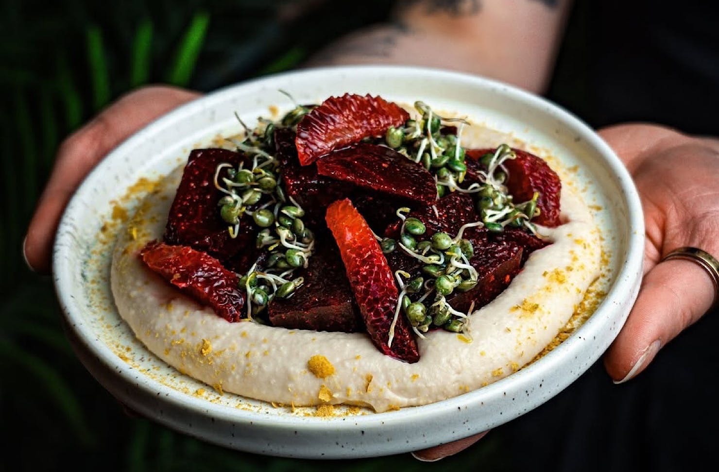 A delectable looking plate topped with wedges of ruby red grapefruit. 