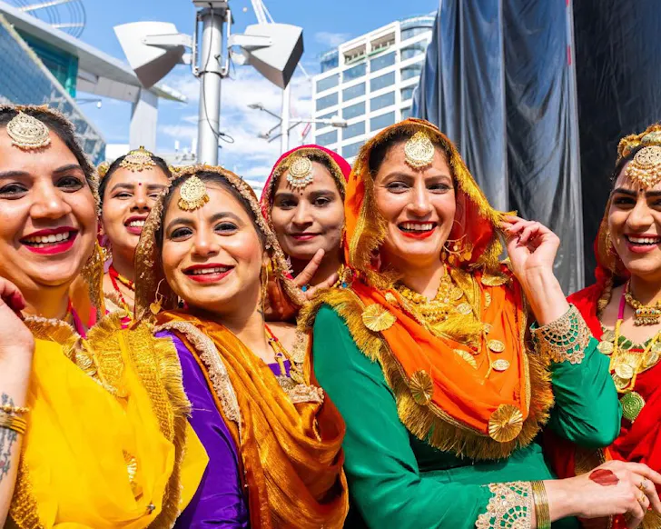 A bunch of happy women in saris.