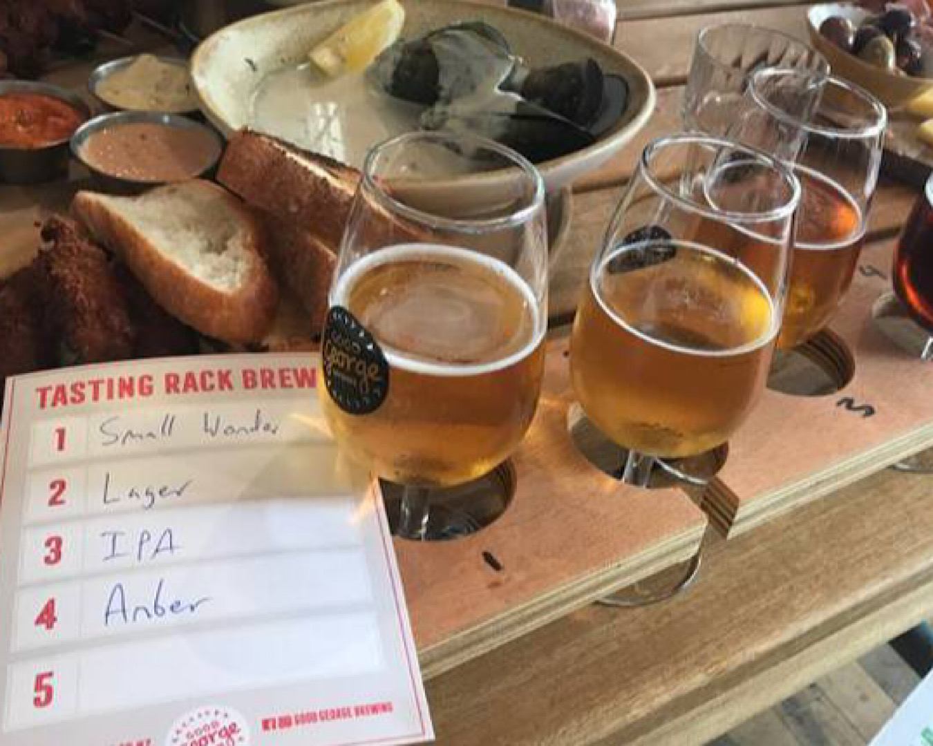 A table is laden with pints of craft beer and snacks at the Auckland Urban Craft Beer Tour. 