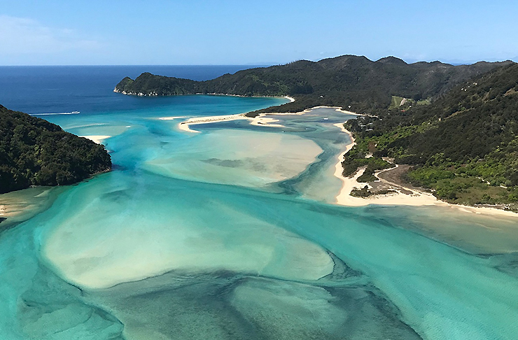 Beautiful blue sea and beaches shows Awaroa Bay from above