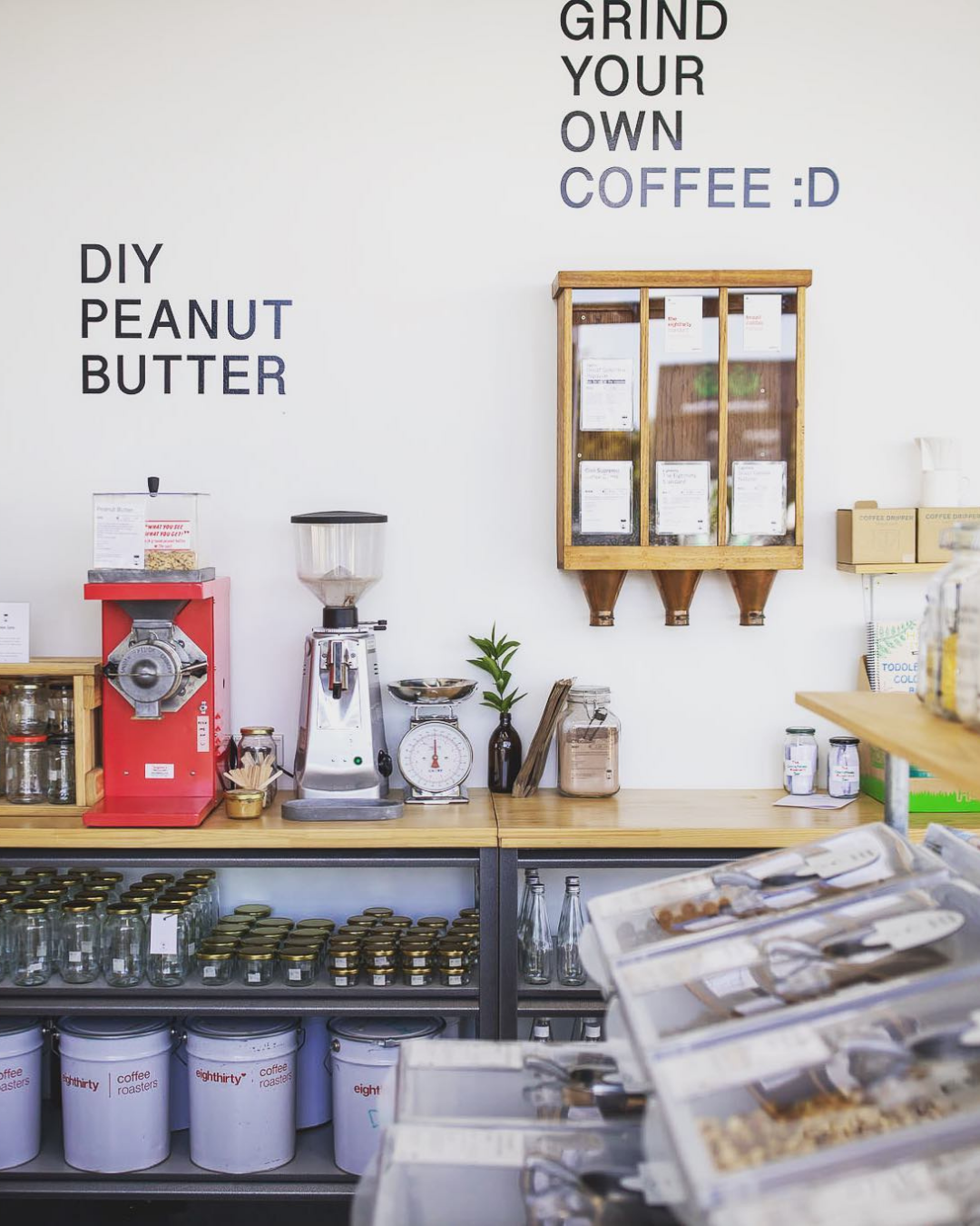 A wall filled with bulk bin goodies including DIY peanut butter and grind-your-own coffee.