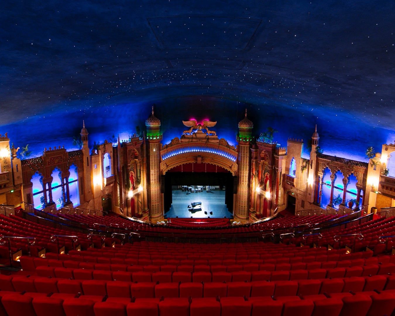 Auckland’s Civic Theatre, shot from the seats looking towards the stage. You can see a deep blue ‘night sky’ above, glittering with stars. 