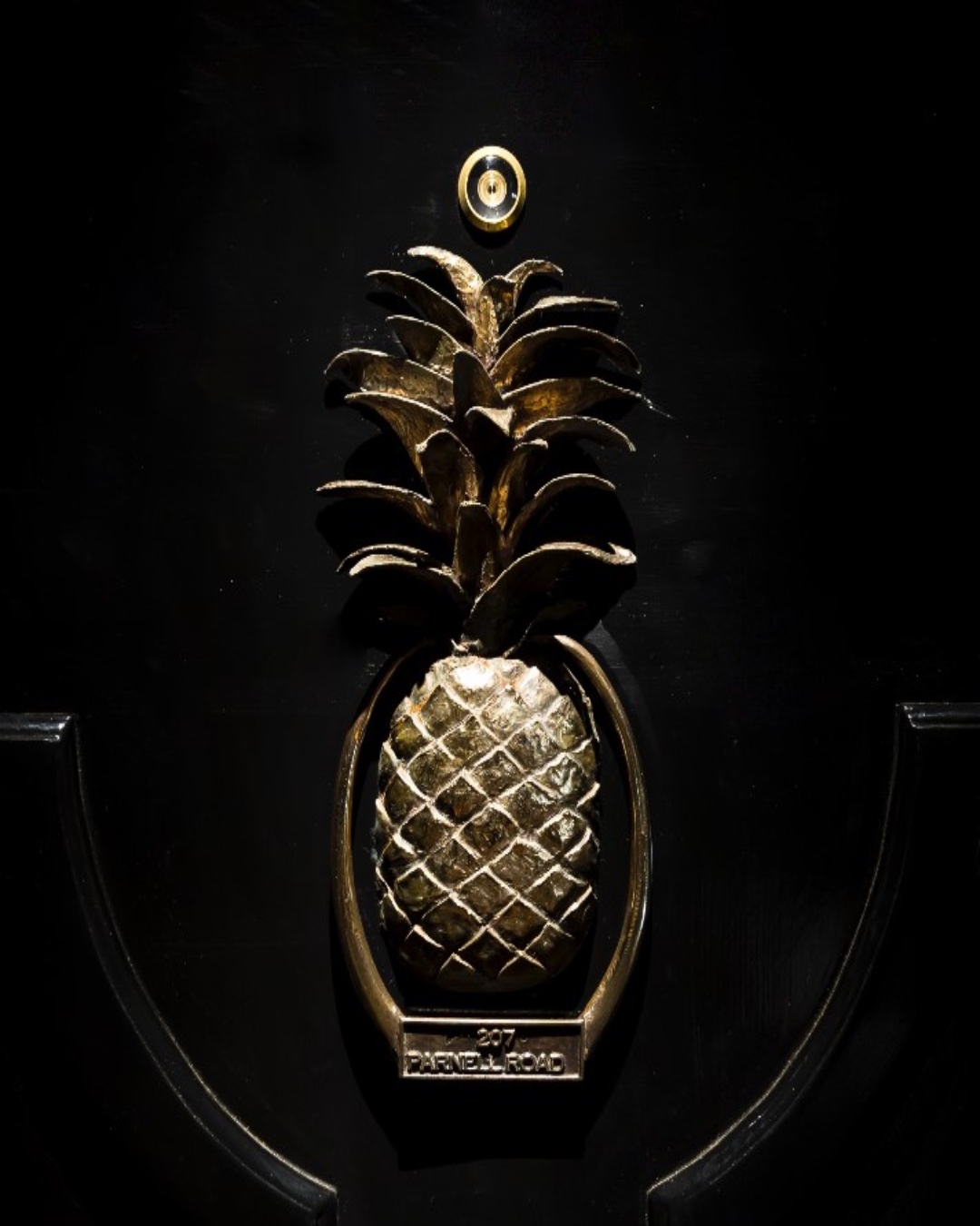 Brass pineapple door knocker on the door to Pineapple on Parnell. 