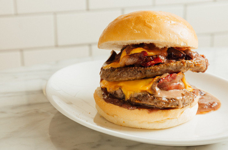 A burger stuffed with double beef patties, bacon, cheese and sauce oozing out, making this one of the best burgers in Melbourne