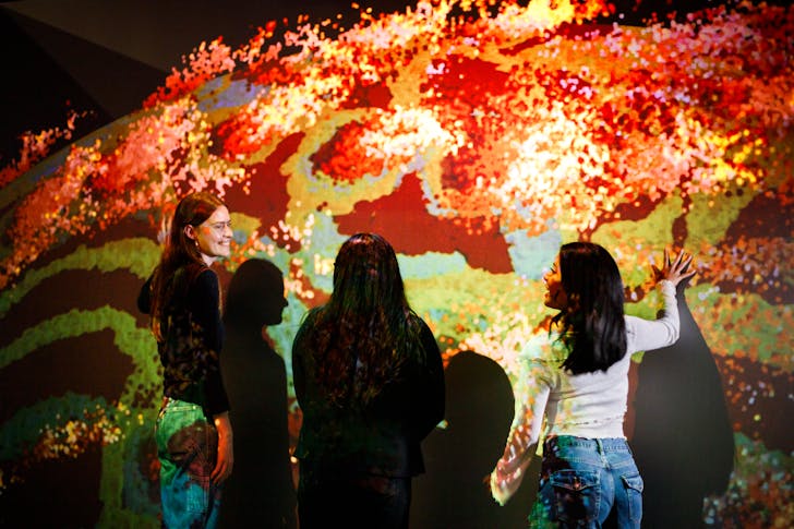 People interacting with screen