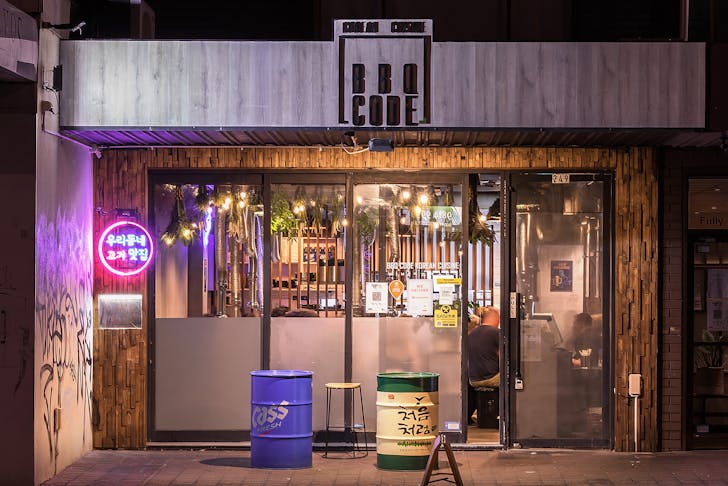 A small shop front with a 'BBQ Code' sign above the sliding door at one of the best Korean restaurants in Melbourne serving korean BBQ