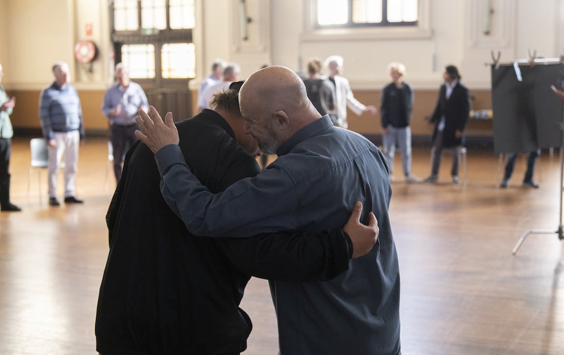 two men patting each others' backs