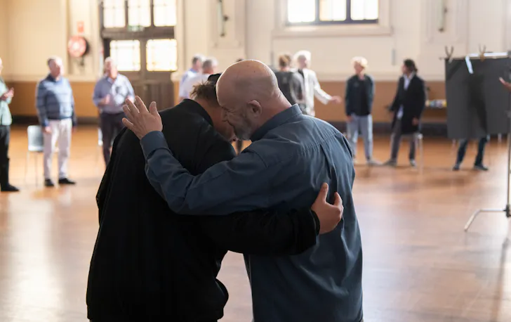 two men patting each others' backs