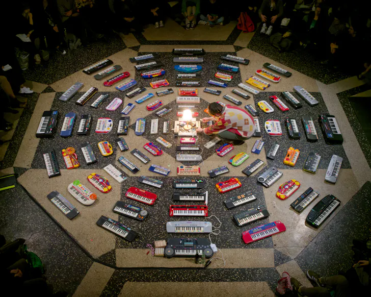 Image of 100 keyboards in hexagon shape on the floor